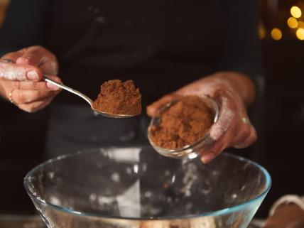 Žena sipa kašiku kakao praha u činiju